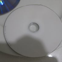 A white cd on a white surface

AI-generated content may be incorrect.