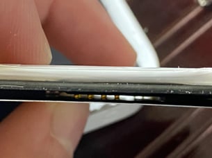 A close up of a hand holding a black and white object

AI-generated content may be incorrect.